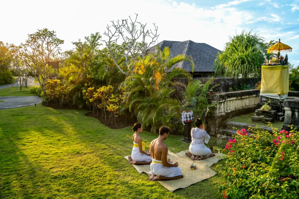 bali nature & wellness Tour package from bhubaneswar odisha - Person meditating at a serene Bali temple, for the spiritual wellness tour.