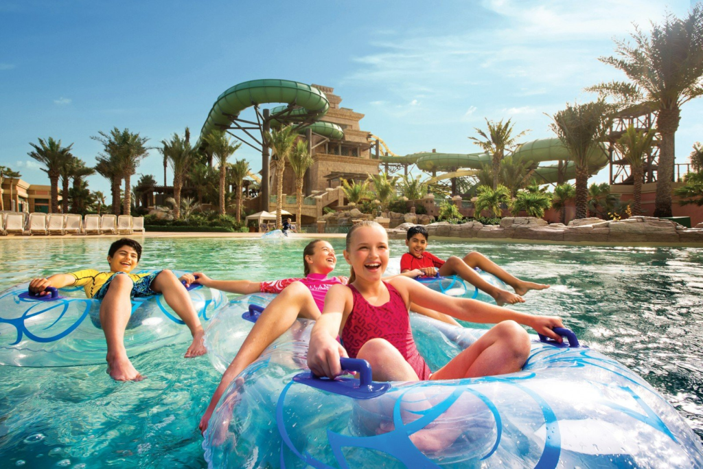 Family with kids enjoying water rides at Atlantis Aquaventure Waterpark in Dubai