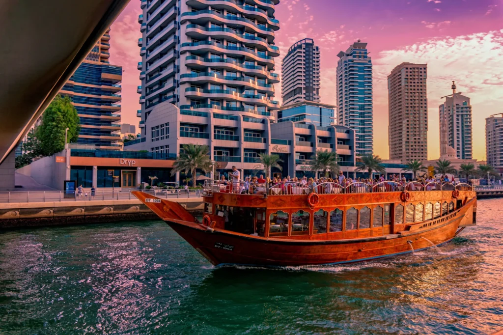 Couple holding hands on a romantic Dhow cruise at Dubai Marina with city lights